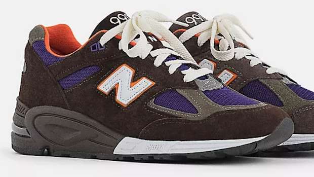 View of brown and purple New Balance shoes.